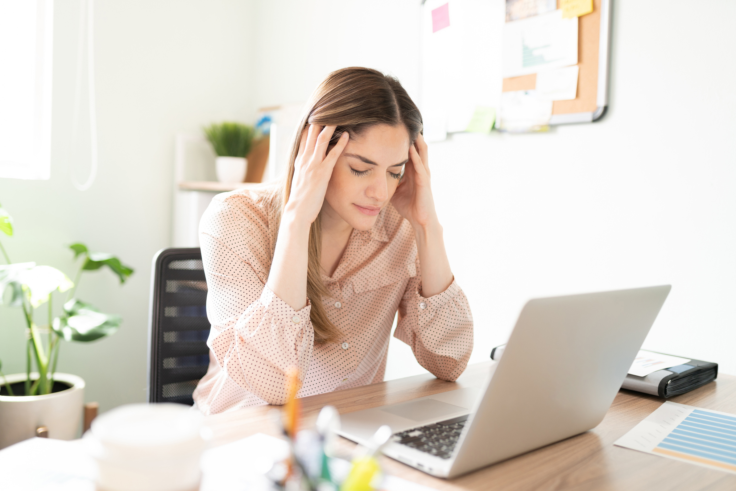 Stressed and overwhelmed woman at work